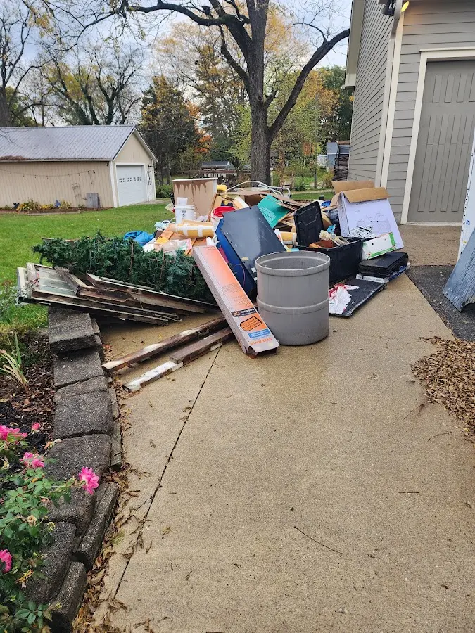 Dumpster being loaded with debris for Estate Cleanout Dumpster Rental in Golden Beach